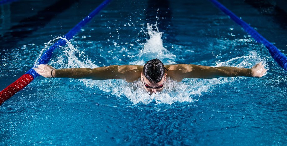man swimming with butterfly stroke